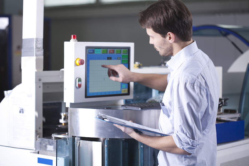 man looking at robotic control system 