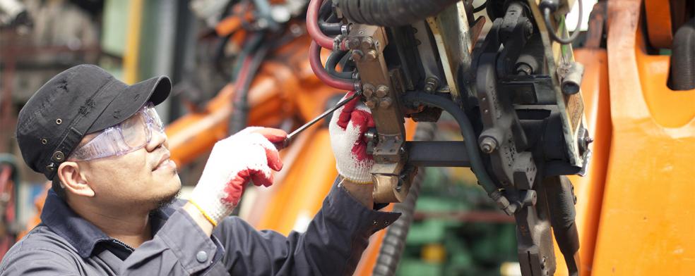 Image of a man working on a robot